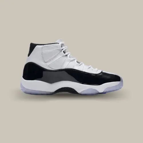 La Air Jordan 11 Retro Concord (2018) avec sa tige de couleur blanche et son mudguard en cuir noir verni.