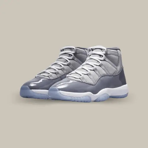 La Air Jordan 11 Retro Cool Grey (2021) possède une base en cuir gris accompagné par son mudguard qui fait le tour de toute l'empeigne en cuir verni gris foncé. Le tout repose sur une semelee icy bleu clair.&nbsp; Les logos "23" et le jumpman se retrouve sur le talon pour conclure le design de cette magnifique paire.